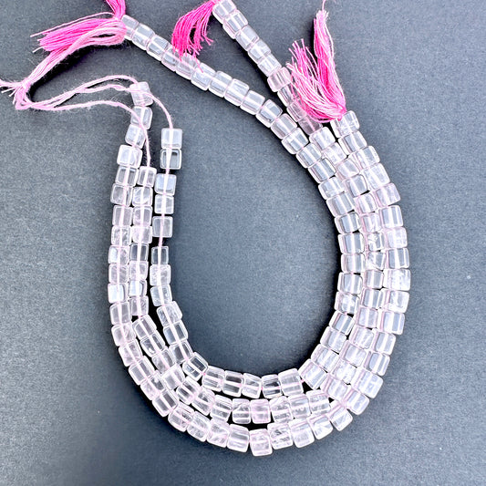Natural gemstone beads in Rose Quartz, arranged on a 20cm strand with consistent square cut.