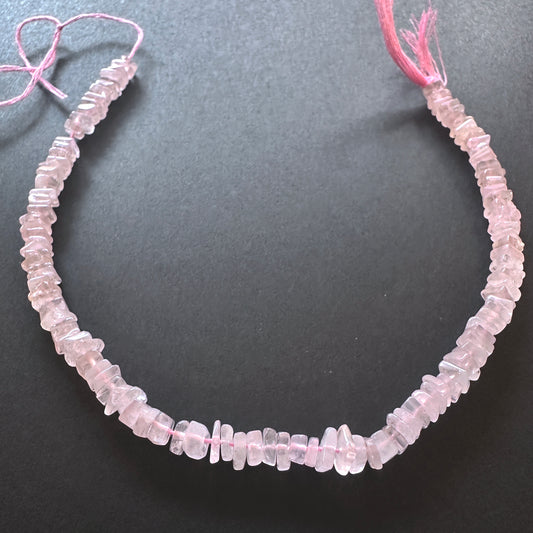 Stone beads with square-cut Rose Quartz arranged neatly, ideal for handmade jewellery components.