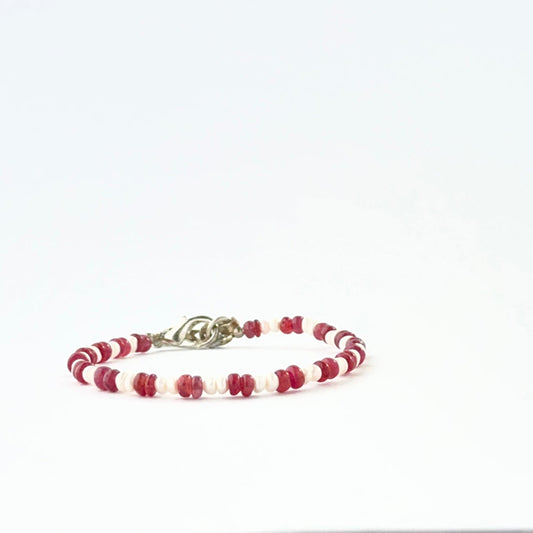Ruby and freshwater pearl bracelet crafted with smooth rondelle 3.7–4mm beads and adjustable fit.