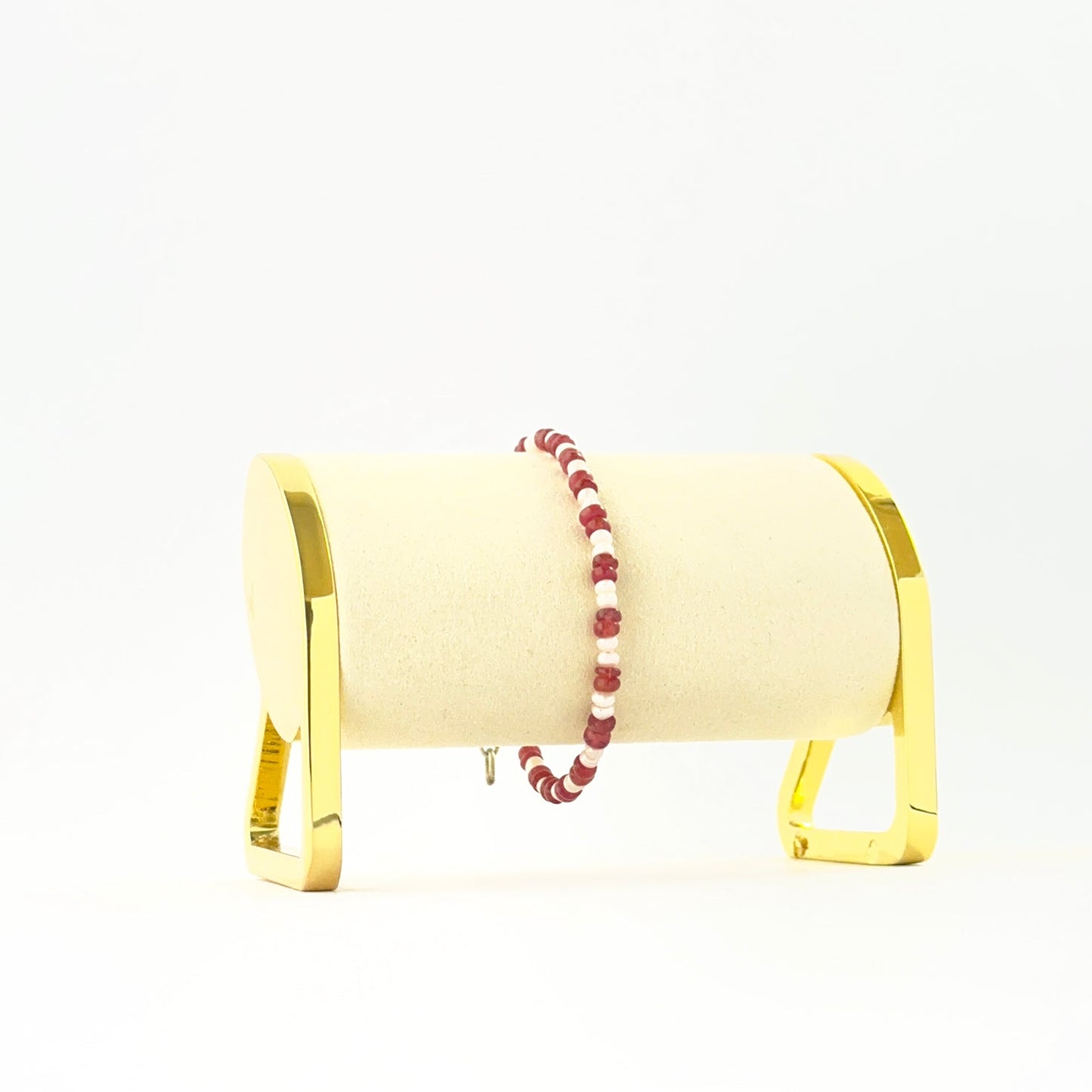 Elegant ruby and pearl bracelet showcasing smooth rondelle beads in a single 18cm strand.