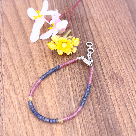 Close-up of natural gemstone beads featuring Ruby, Blue and Yellow Sapphire in vibrant colours.