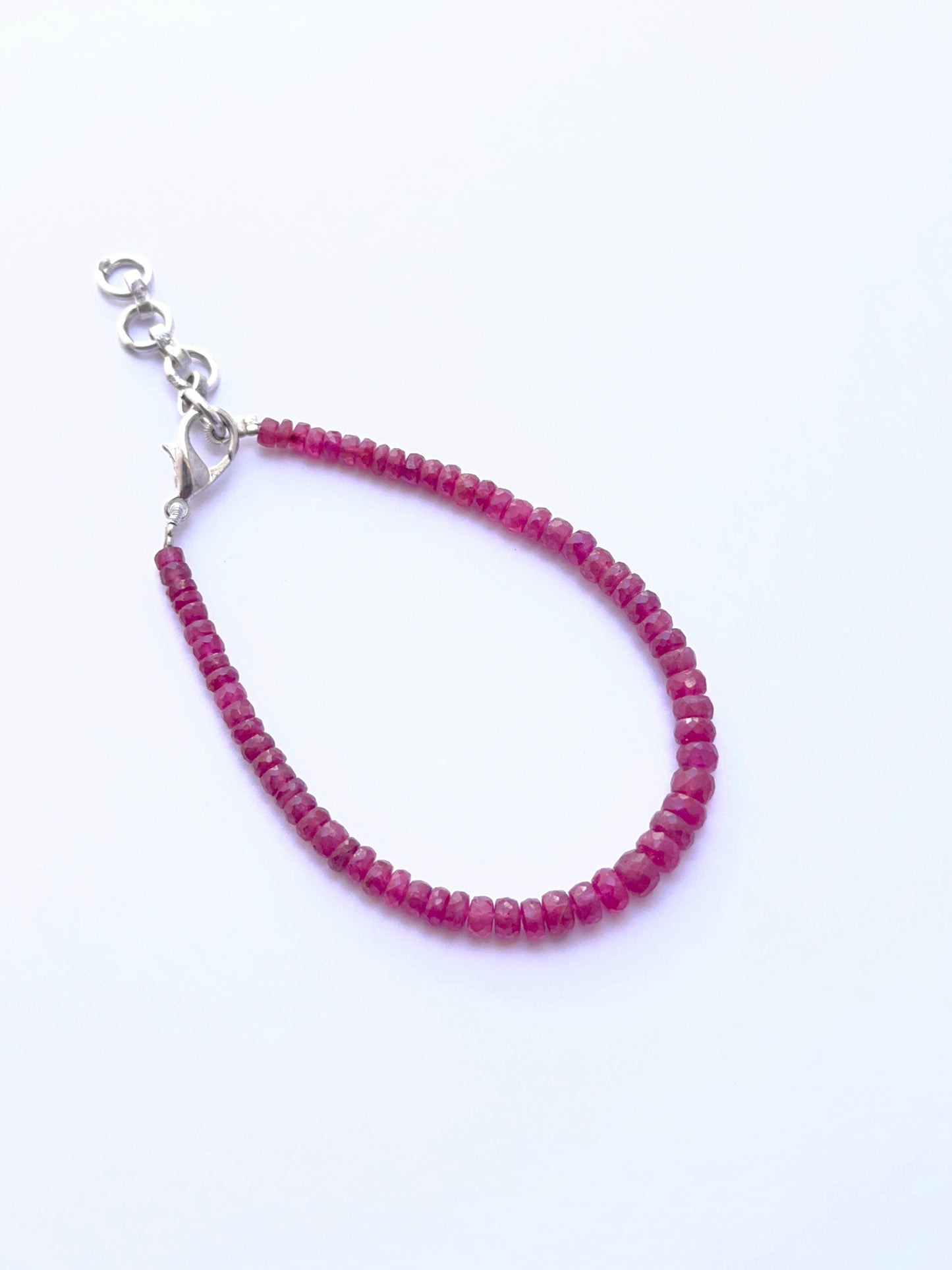 Ruby bracelet with faceted rondelles arranged in a polished design.