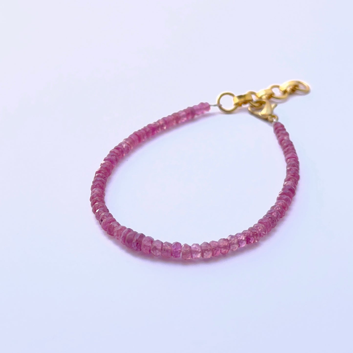 Ruby bracelet with faceted rondelles arranged in a polished design.