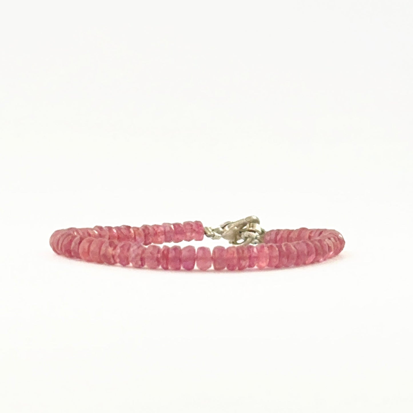 Ruby bead bracelet arranged with faceted rondelle beads and adjustable fit.