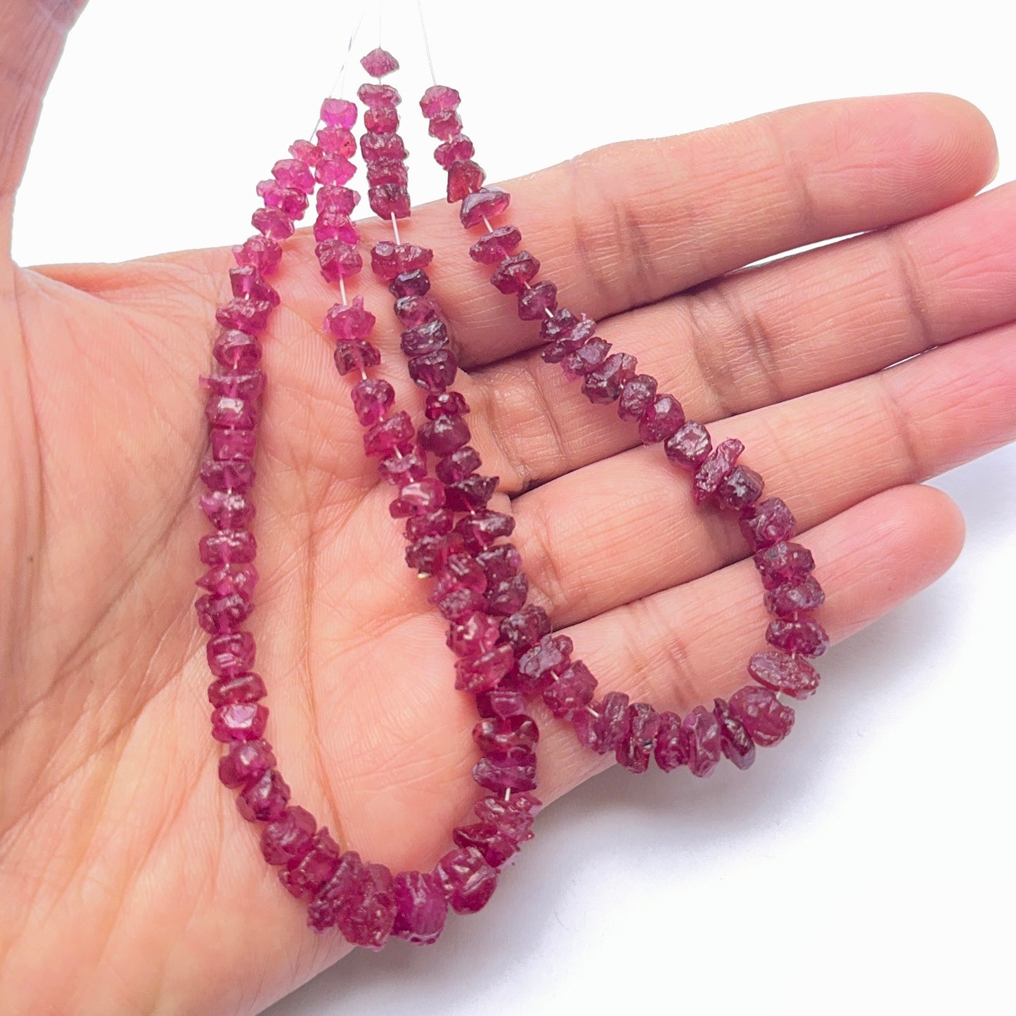 Ruby bead strand featuring rough ruby beads in a bold, earthy style.