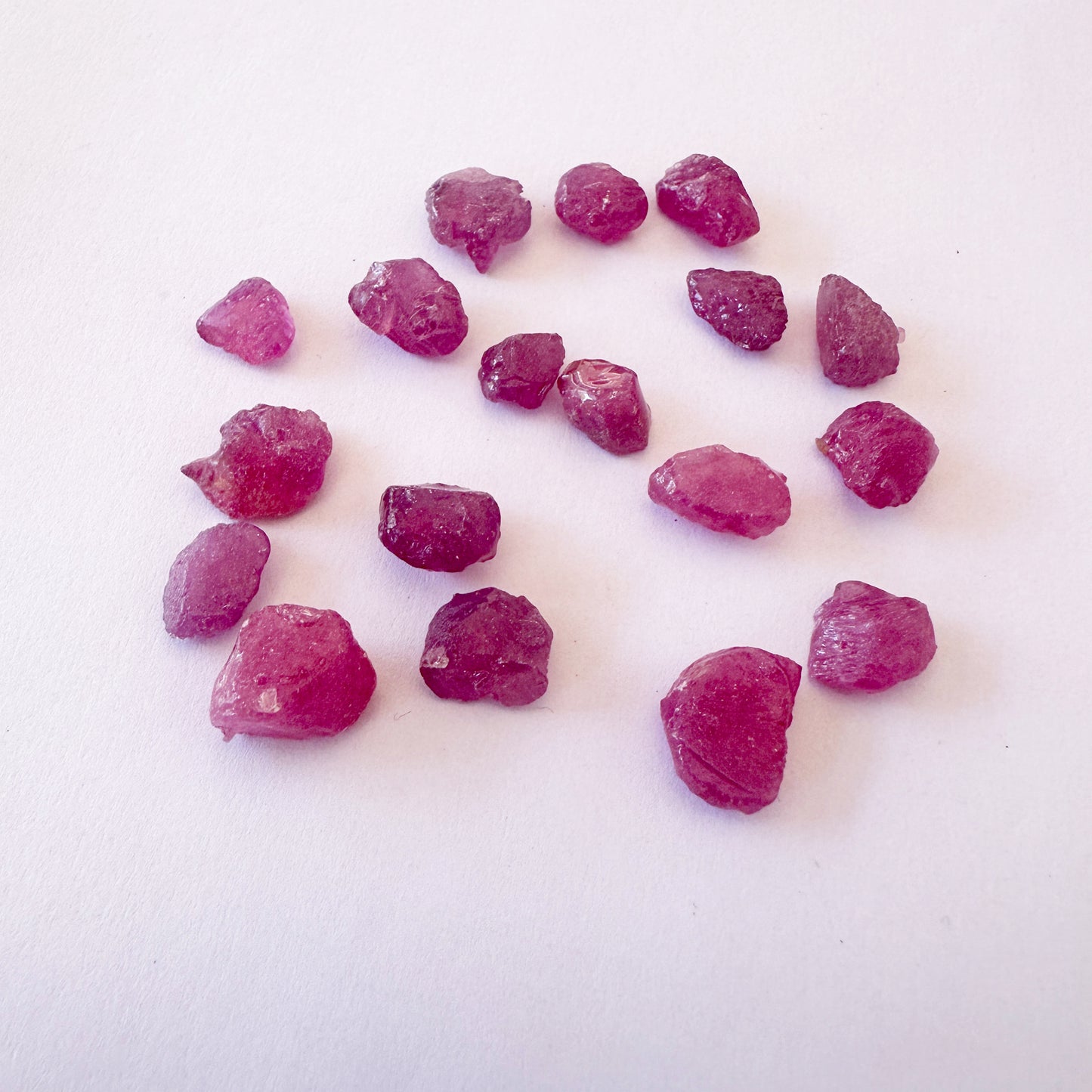 Ruby roughs arranged in a cluster, highlighting their organic shape and shine.