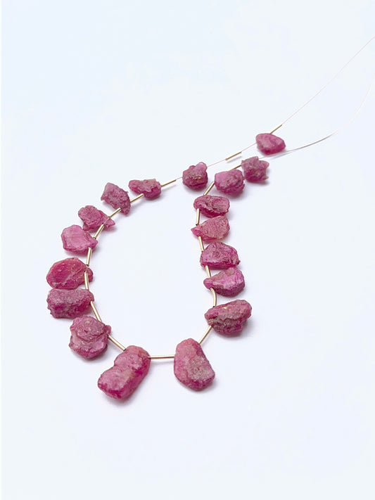 Close‑up of ruby rough stone beads highlighting their organic shape and rich colour for DIY jewellery.