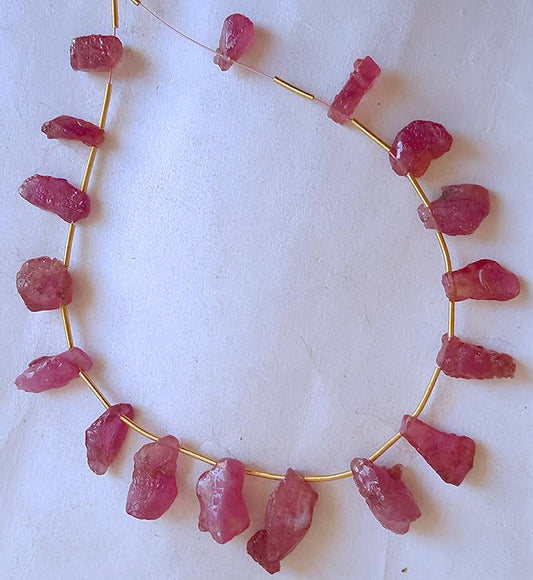 Ruby rough side drill beads in mixed sizes from 9x6mm to 18x8mm with deep red hues and natural texture.