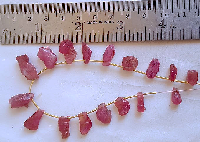 A ruler measures the Ruby rough cut gemstone.