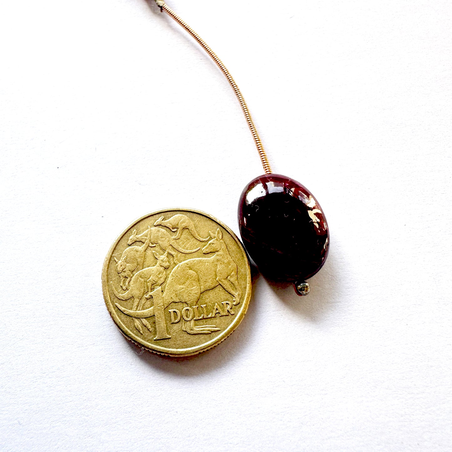 Ruby oval bead displayed as a focal gemstone with rich colour and shine.