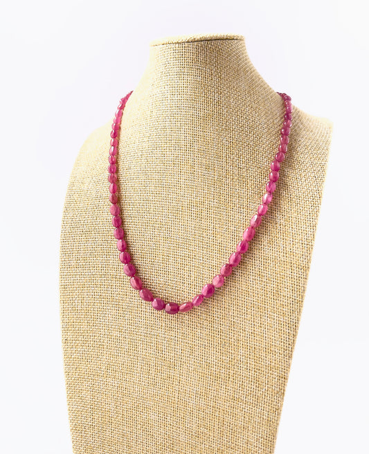 Genuine Ruby smooth oval beads showcasing deep red tones and glossy surfaces in a 182‑carat adjustable necklace.