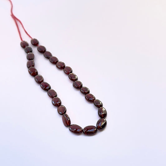 Ruby smooth oval beads 7.5–8.5mm x 6mm, 26 pieces, rich red colour for handmade jewellery components.
