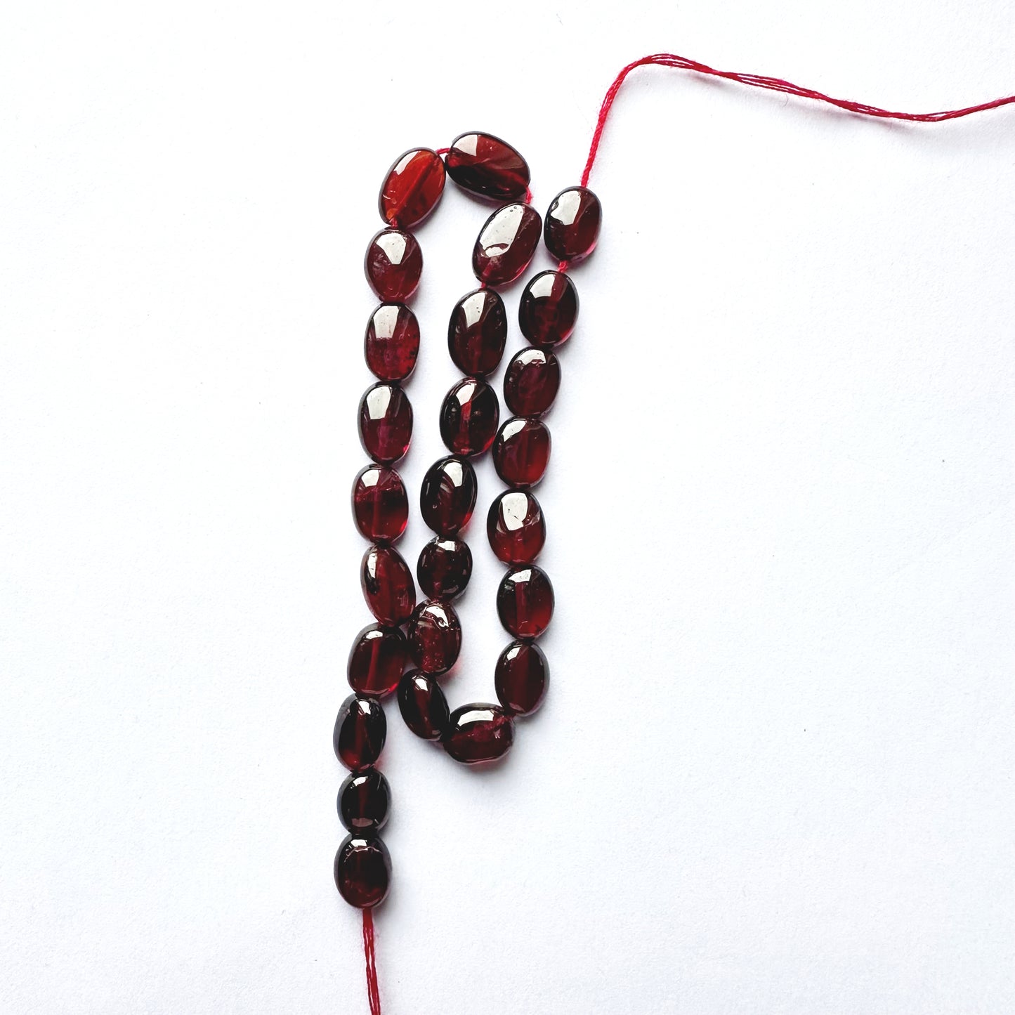 Ruby smooth oval beads with deep red colour and polished 7.5–8.5mm x 6mm finish.