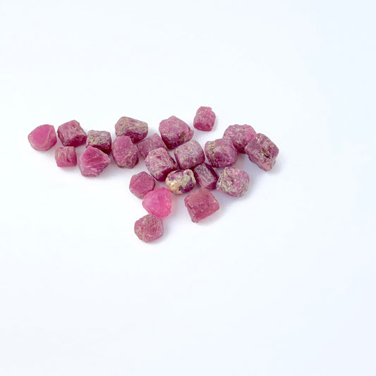 Close‑up of undrilled Ruby rough pieces arranged to highlight crystal form.