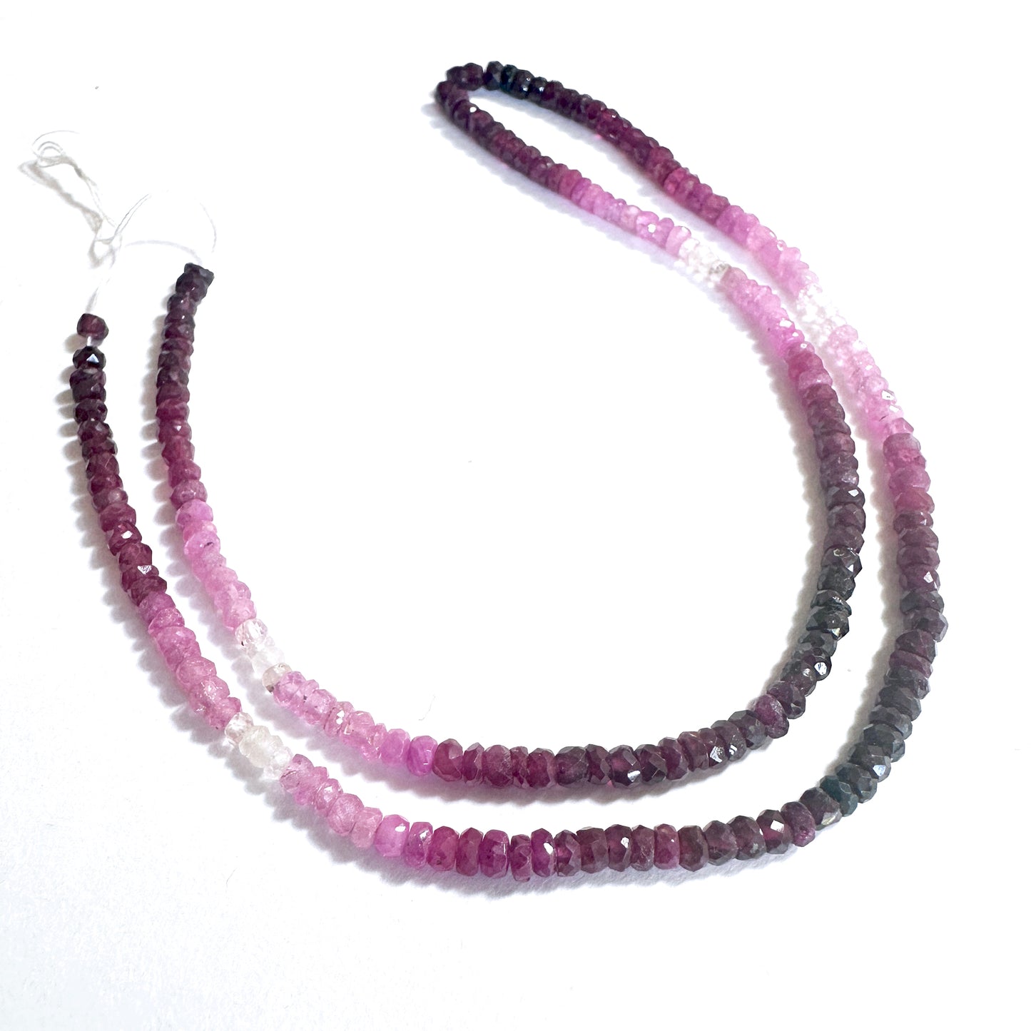 Faceted ruby rondelle beads arranged in a neat strand with consistent sizing and clarity.