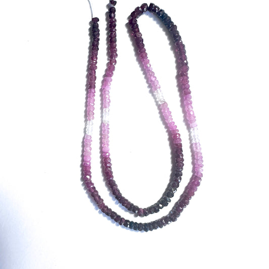 Close-up of 3.4mm ruby beads showing vivid green tones and polished faceted surfaces.