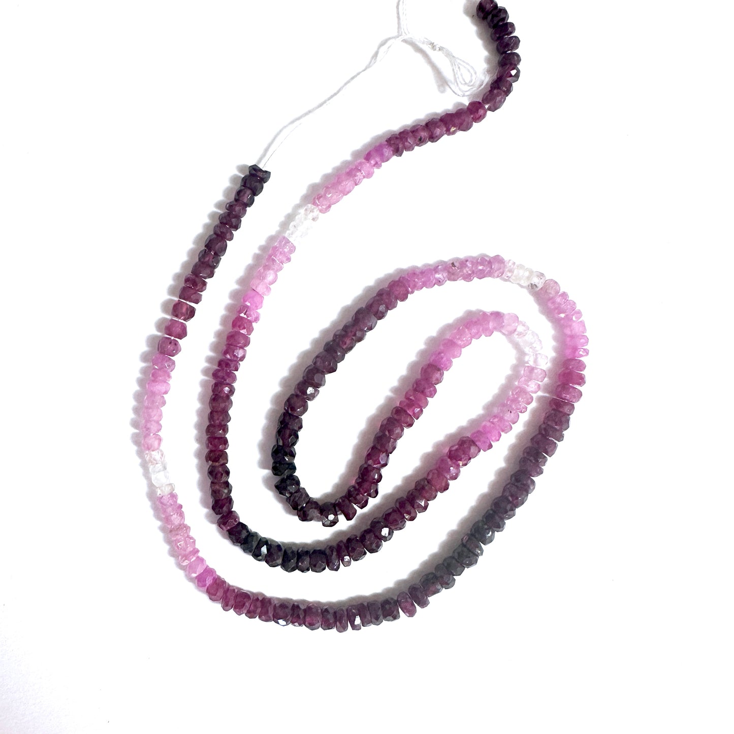 3.4mm Ruby beads showing vivid green tones and polished faceted surfaces.