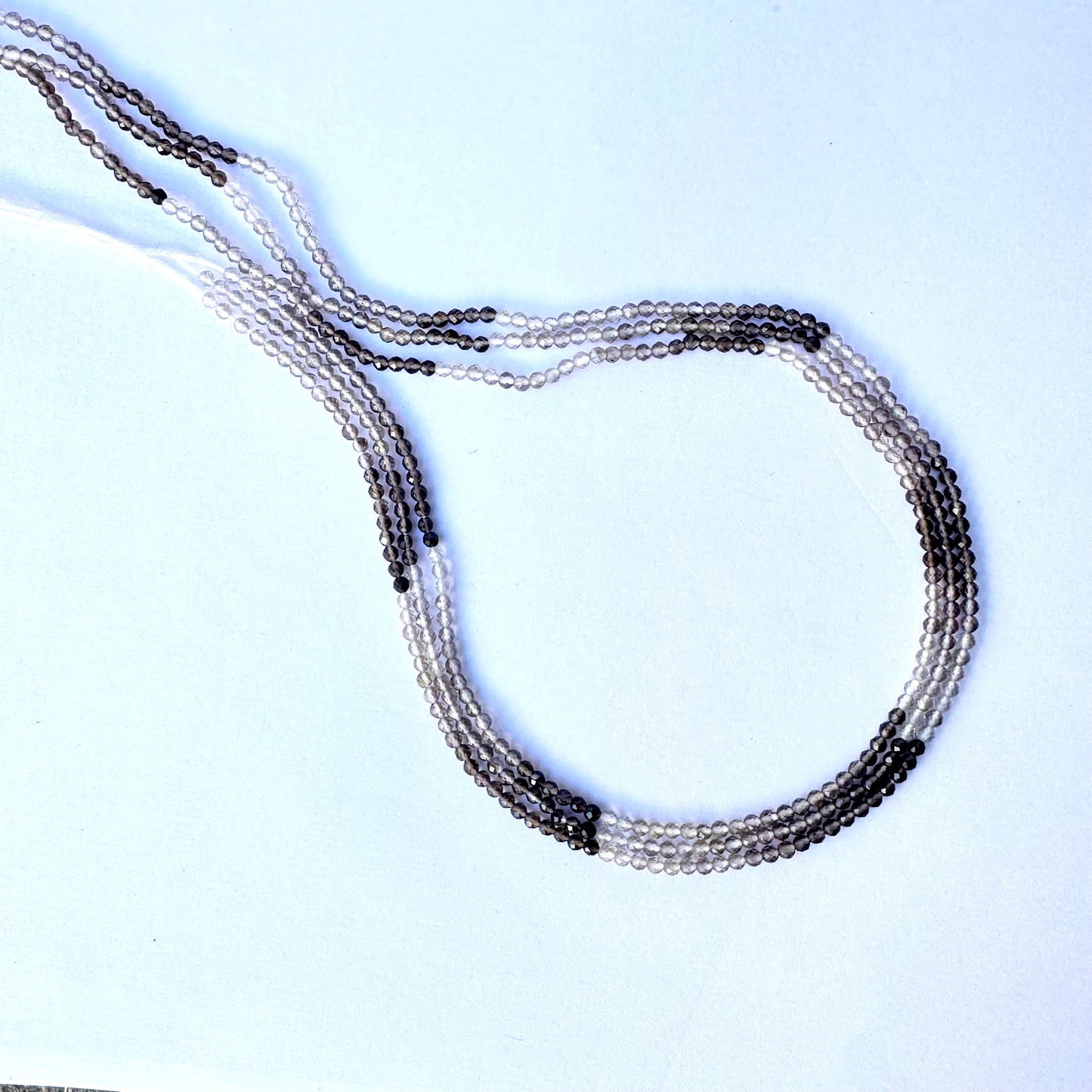 Shaded smoky quartz rondelle beads with 2.2mm size and faceted finish on a 32cm strand.