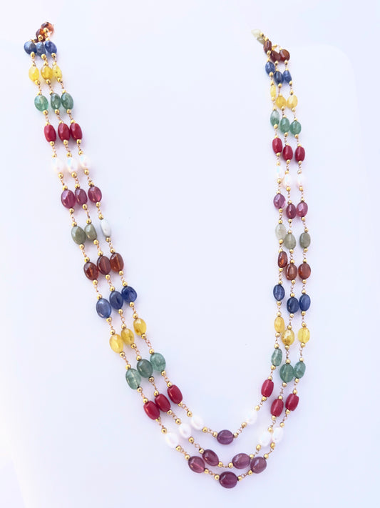 Close-up of Navratan gemstone beads, smooth oval cut, polished finish, arranged in strands.