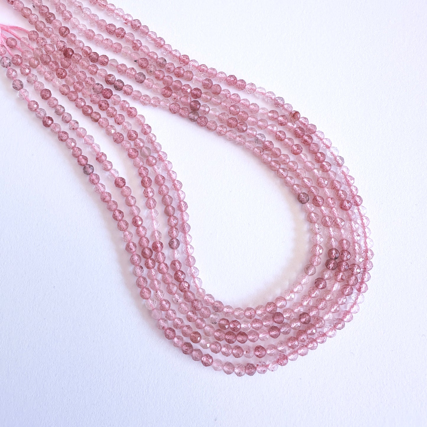Handmade jewellery components with Strawberry Quartz beads arranged in a 31cm strand, ideal for romantic and elegant designs.