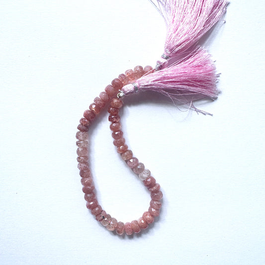 Close-up of natural gemstone beads for DIY jewellery showing faceted cut and radiant sparkle.