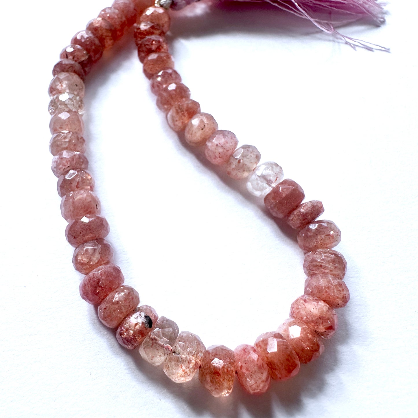 Stone Beads featuring Sunstone with consistent rondelle shape and shimmering surface.