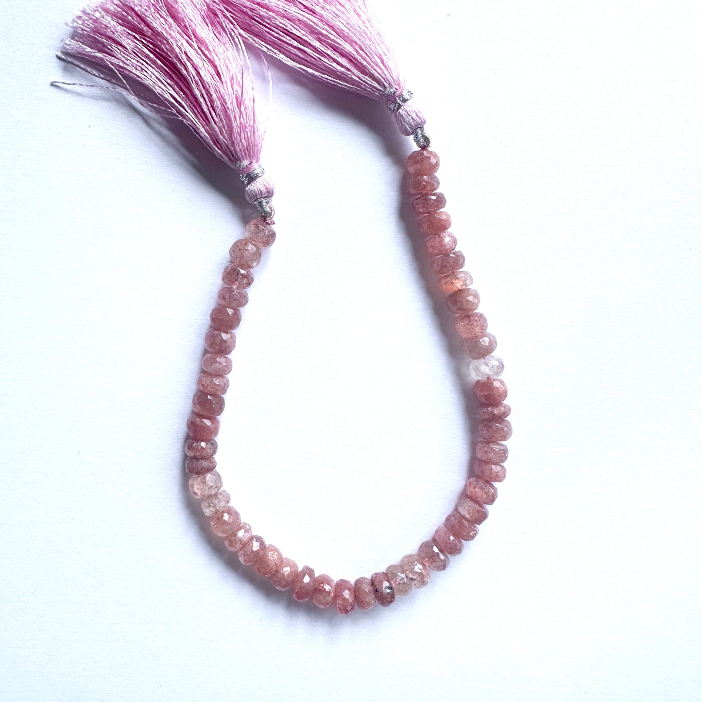 A dial gauge measures the Sunstone faceted rondelle gemstone.