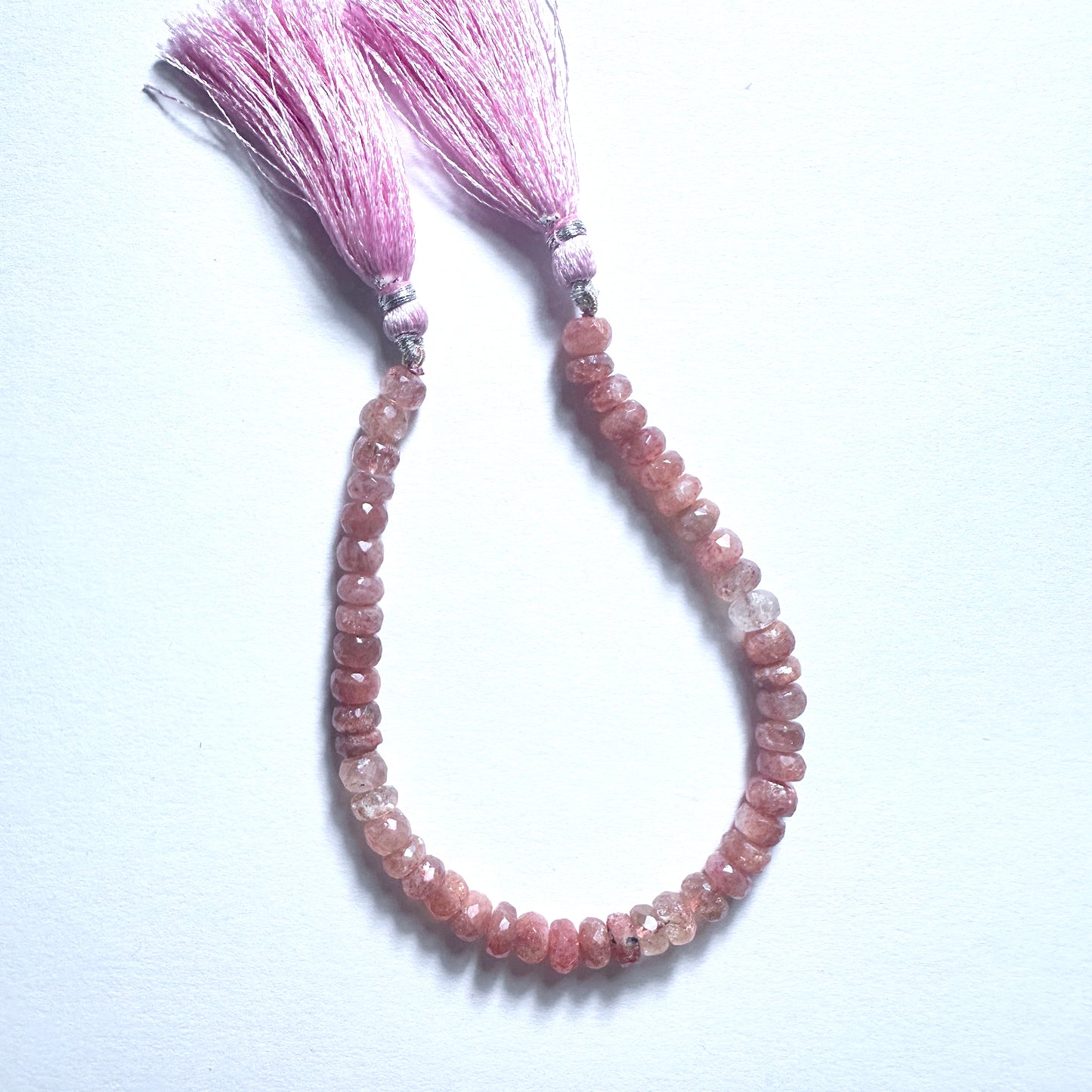 Sunstone faceted rondelle beads in warm copper tones, arranged on a 20cm strand with polished finish.