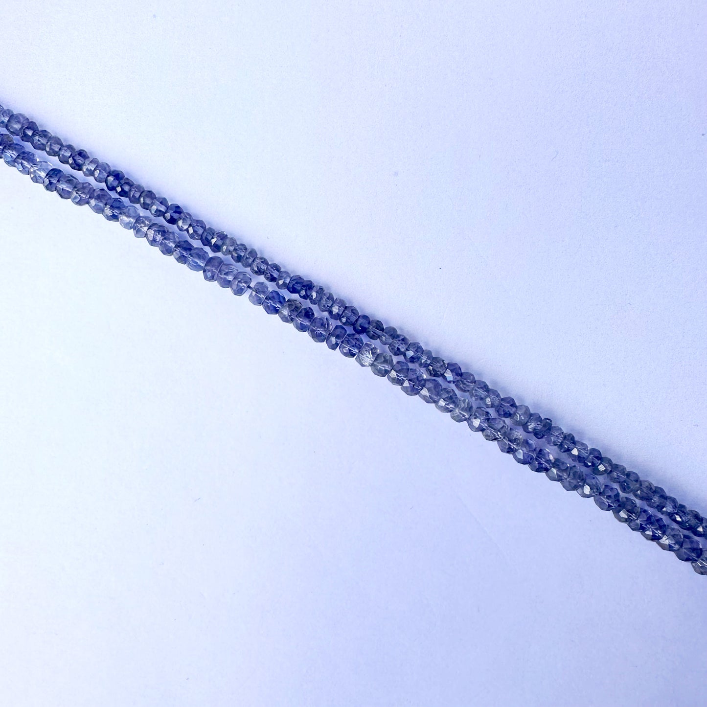 High-quality Tanzanite rondelles with 0.5mm bead holes and shimmering surface.