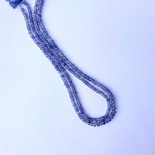 Tanzanite beads arranged in a strand with consistent cut and radiant clarity.
