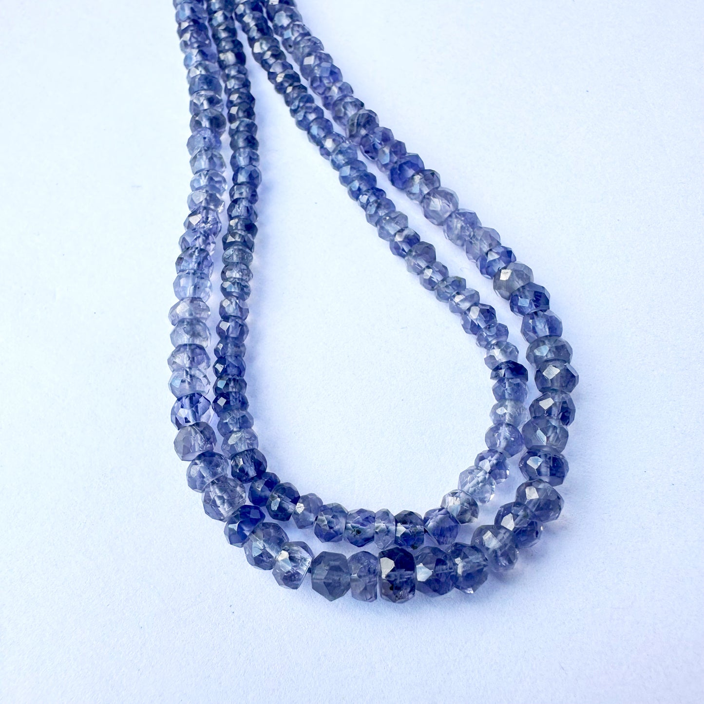 Close-up of Tanzanite beads showing vivid violet-blue colour and polished facets.