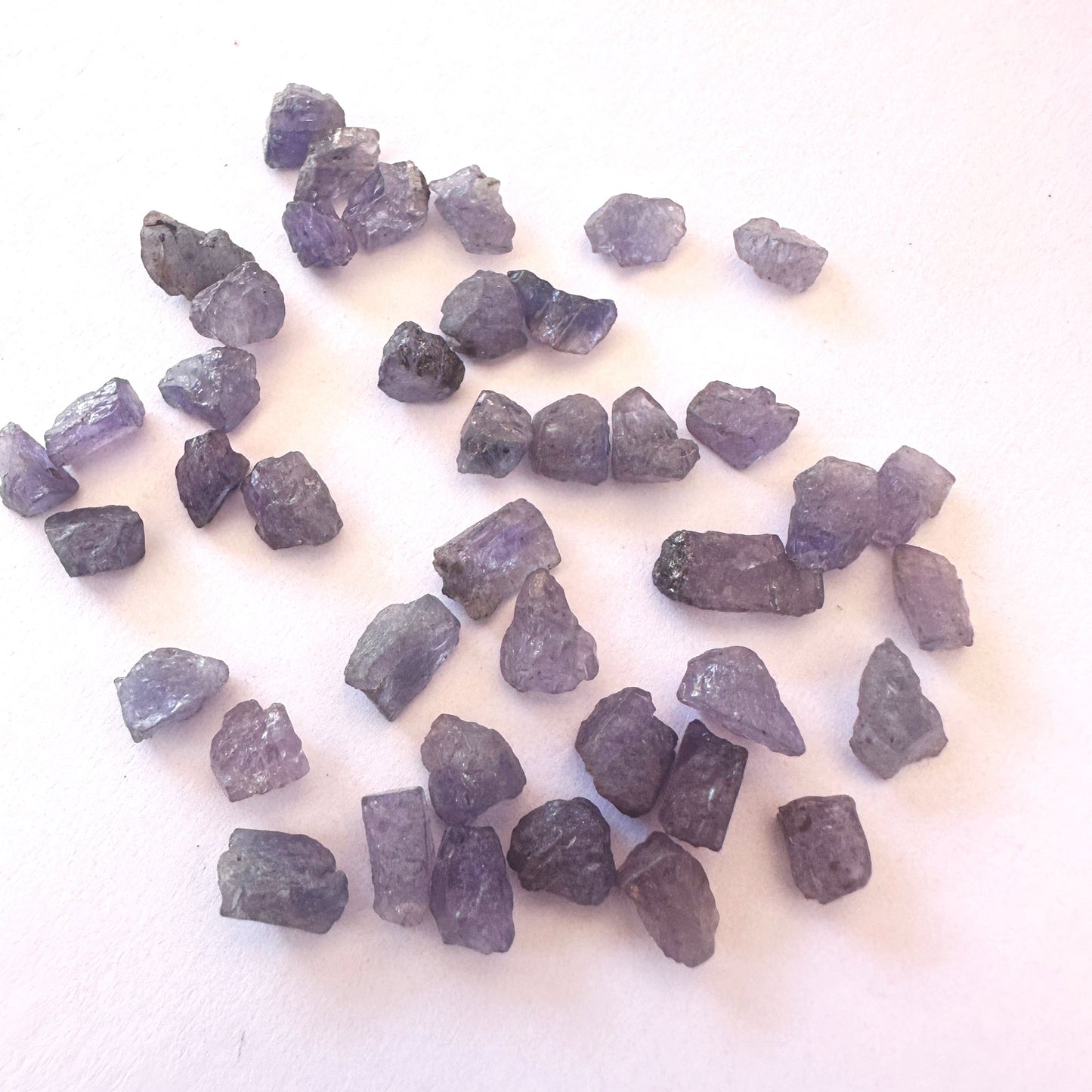 Uncut Tanzanite gemstones showing raw edges and shimmering blue-purple colour.