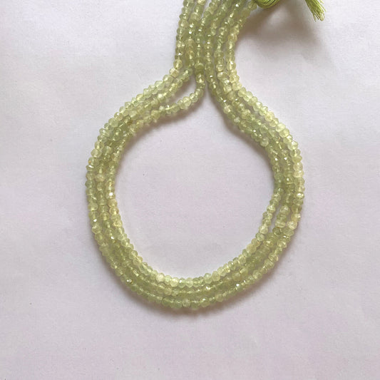 Close-up of Prehnite gemstone beads showing their 4.0-4.2mm size and brilliant faceted cut.