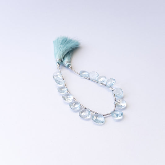 Natural Topaz stone beads with polished faceted briolette shapes, perfect for artisan jewellery components.