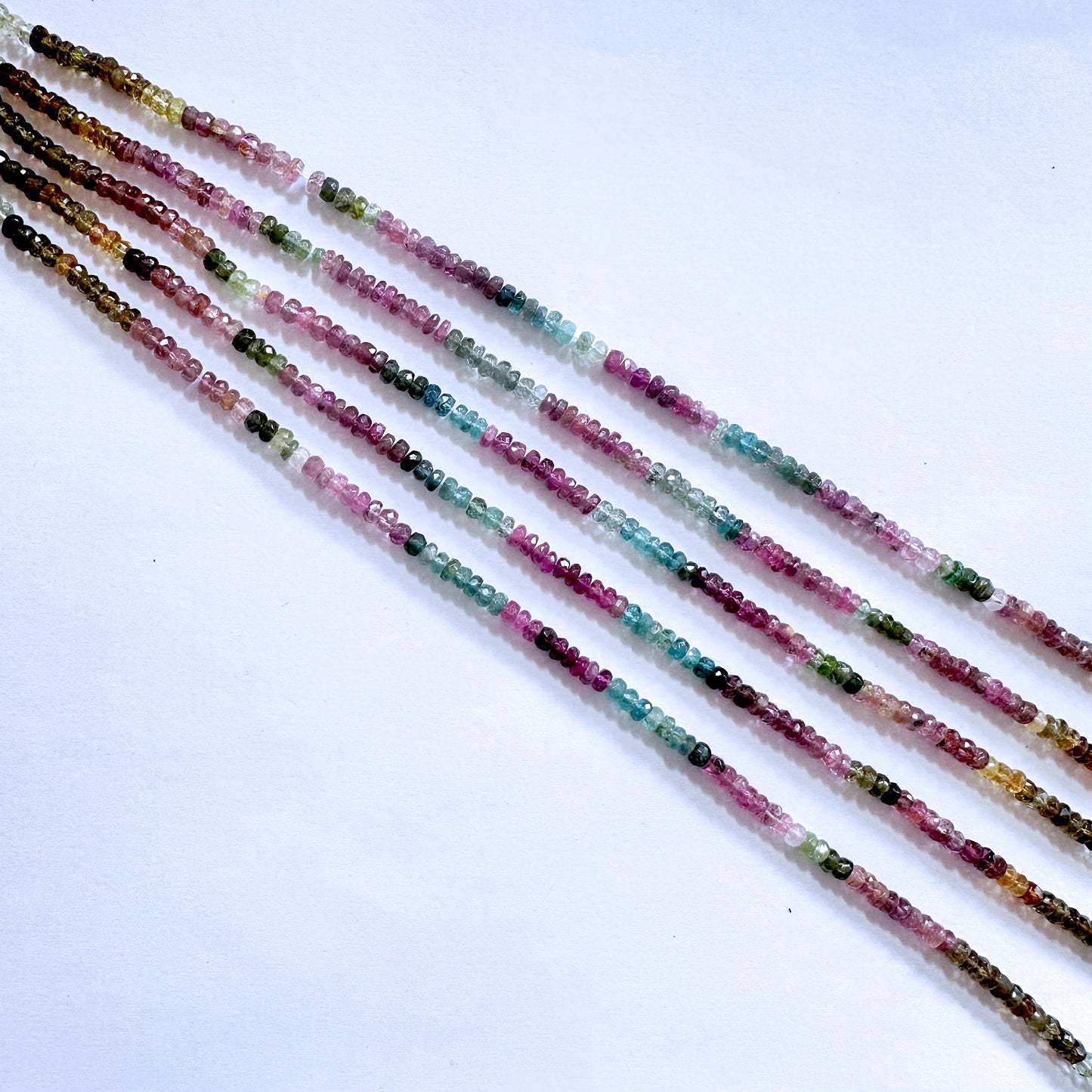 Multicolour Tourmaline gemstones in rondelle cut, reflecting light beautifully with consistent clarity.