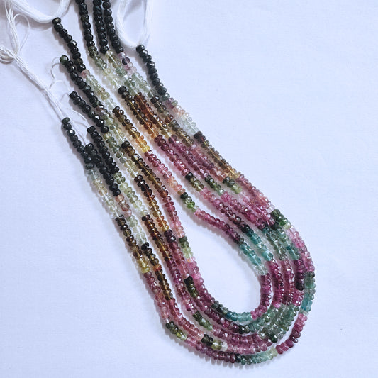 Tourmaline beads in 4.5mm size, showcasing a mix of pink, green, and golden hues with high-quality faceting and shine.