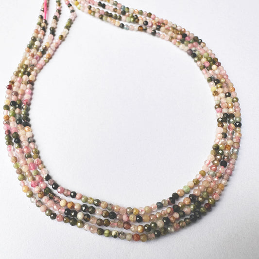 Close-up of Tourmaline beads arranged in a 31cm strand with radiant clarity.