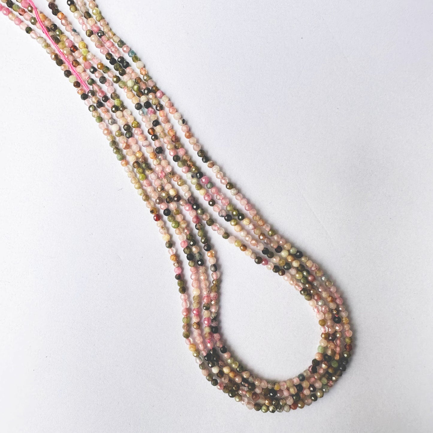 Tourmaline beads with precision faceting and rich multicolour tones.