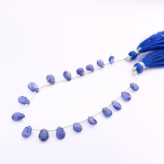 Close‑up of Blue Sapphire pear faceted almond 7–9mm beads highlighting crisp facets and intense sapphire colour.