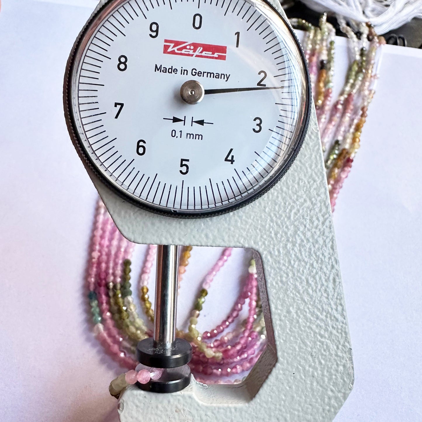 A dial gauge measures the watermelon tourmaline rondelle 2.2mm gemstone
