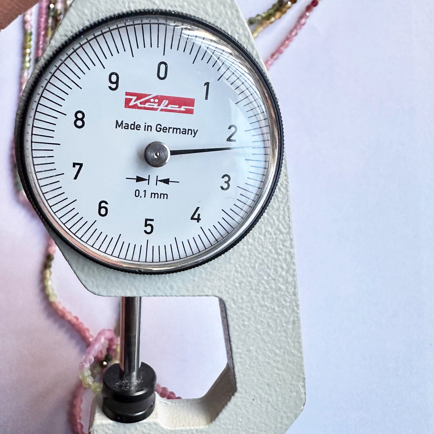 A dial gauge measures the watermelon tourmaline rondelle 2.3mm gemstone