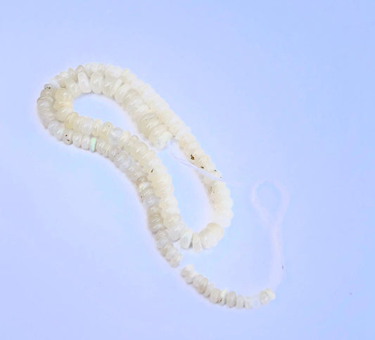 Stone beads arranged on a 20cm strand showcasing polished finish and gentle shine.
