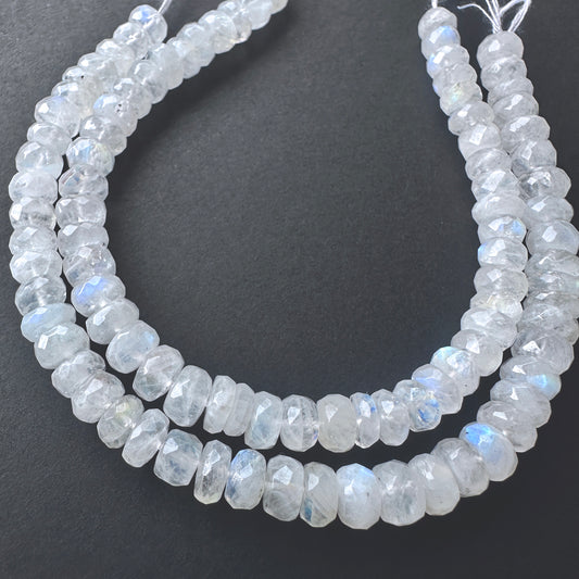 Stone beads with faceted White Rainbow Moonstone arranged neatly, ideal for handmade jewellery components.