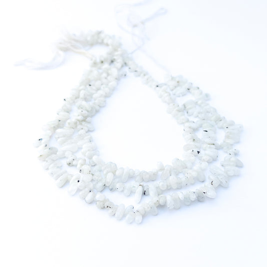 White Rainbow smooth nugget gemstone beads arranged in a 31cm strand, showcasing soft milky tones and gentle shine.