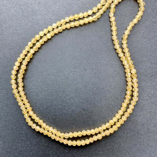 Close-up of Yellow Chalcedony stone beads showing faceted cut and natural gemstone sparkle.