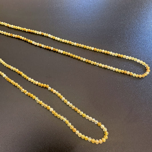Micro faceted yellow opal beads arranged in a neat 32cm strand with consistent sizing and shine.