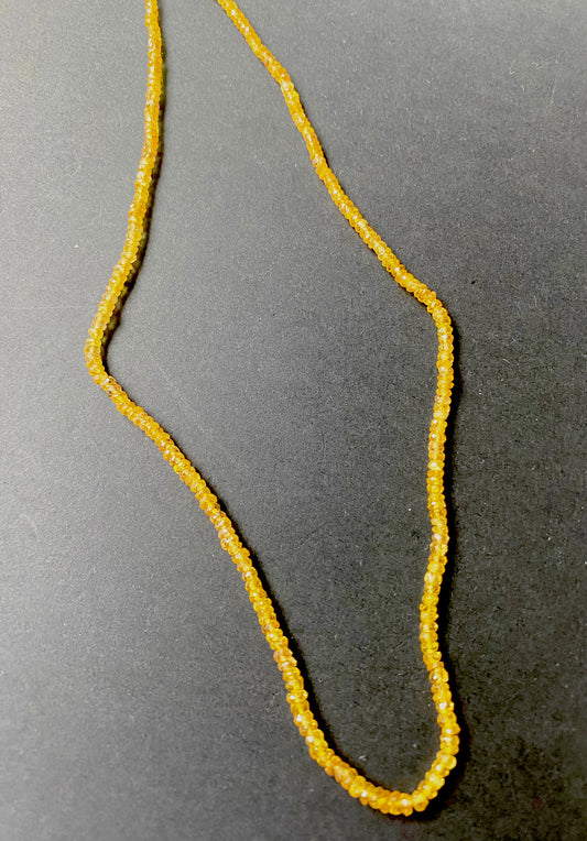Bright golden Yellow Sapphire rondelle beads evenly spaced on a strand with 39.5 carats total weight.