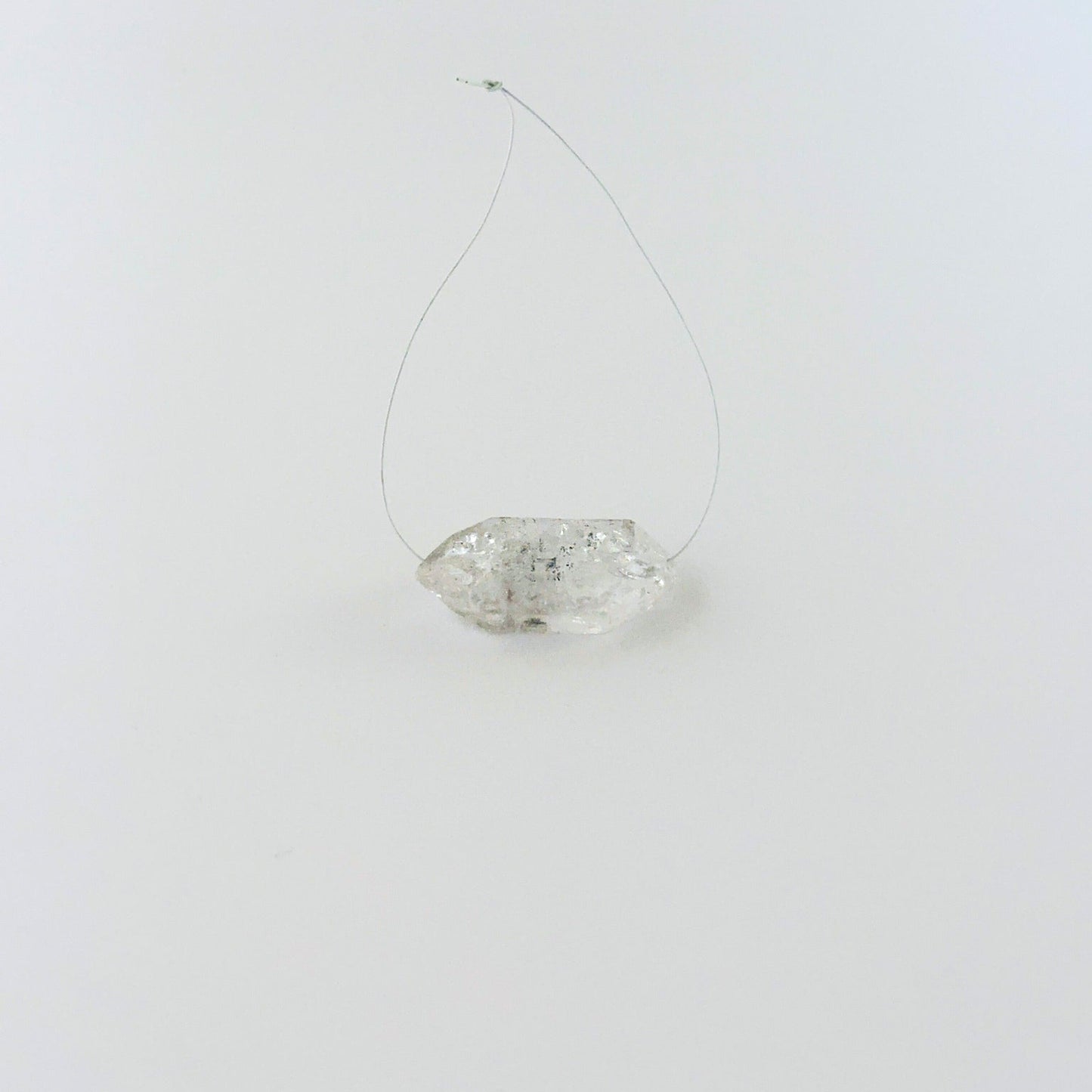 Rough Herkimer Diamond bead arranged for display, highlighting its raw surface and handmade jewellery component quality