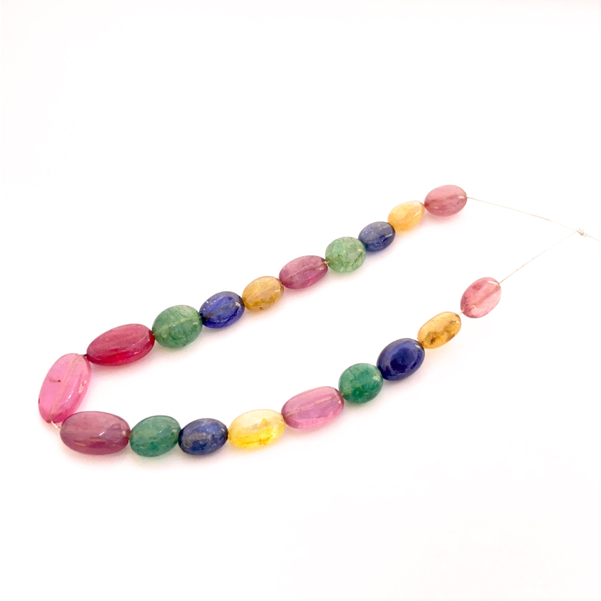 Multi precious smooth oval beads 7x5mm–13x7mm featuring yellow sapphire, blue sapphire, ruby and emerald, 19 pieces, 45 carat.