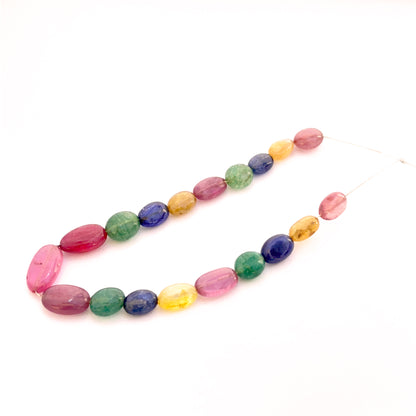 Multi precious smooth oval beads 7x5mm–13x7mm featuring yellow sapphire, blue sapphire, ruby and emerald, 19 pieces, 45 carat.